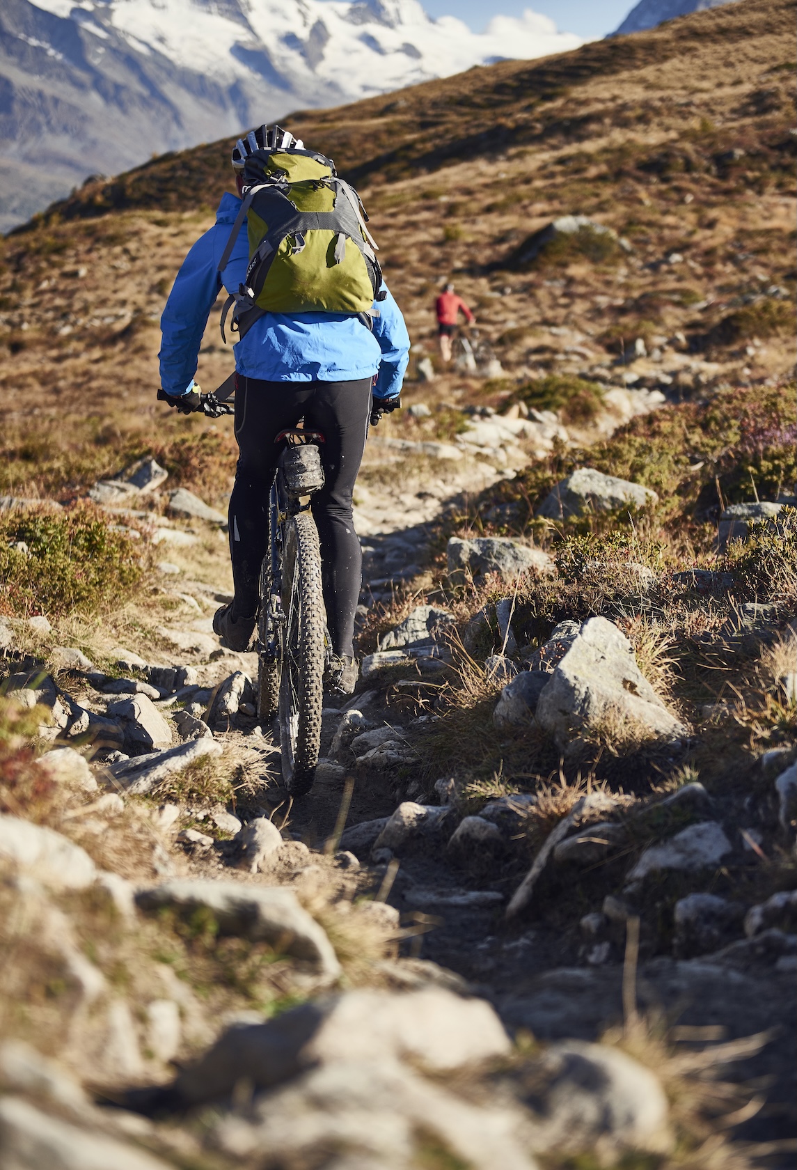Mountain biker riding an Alpine trail in Valais